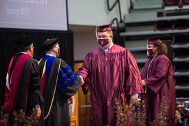 Brandon Martin receiving his diploma from Fairmont State University. 